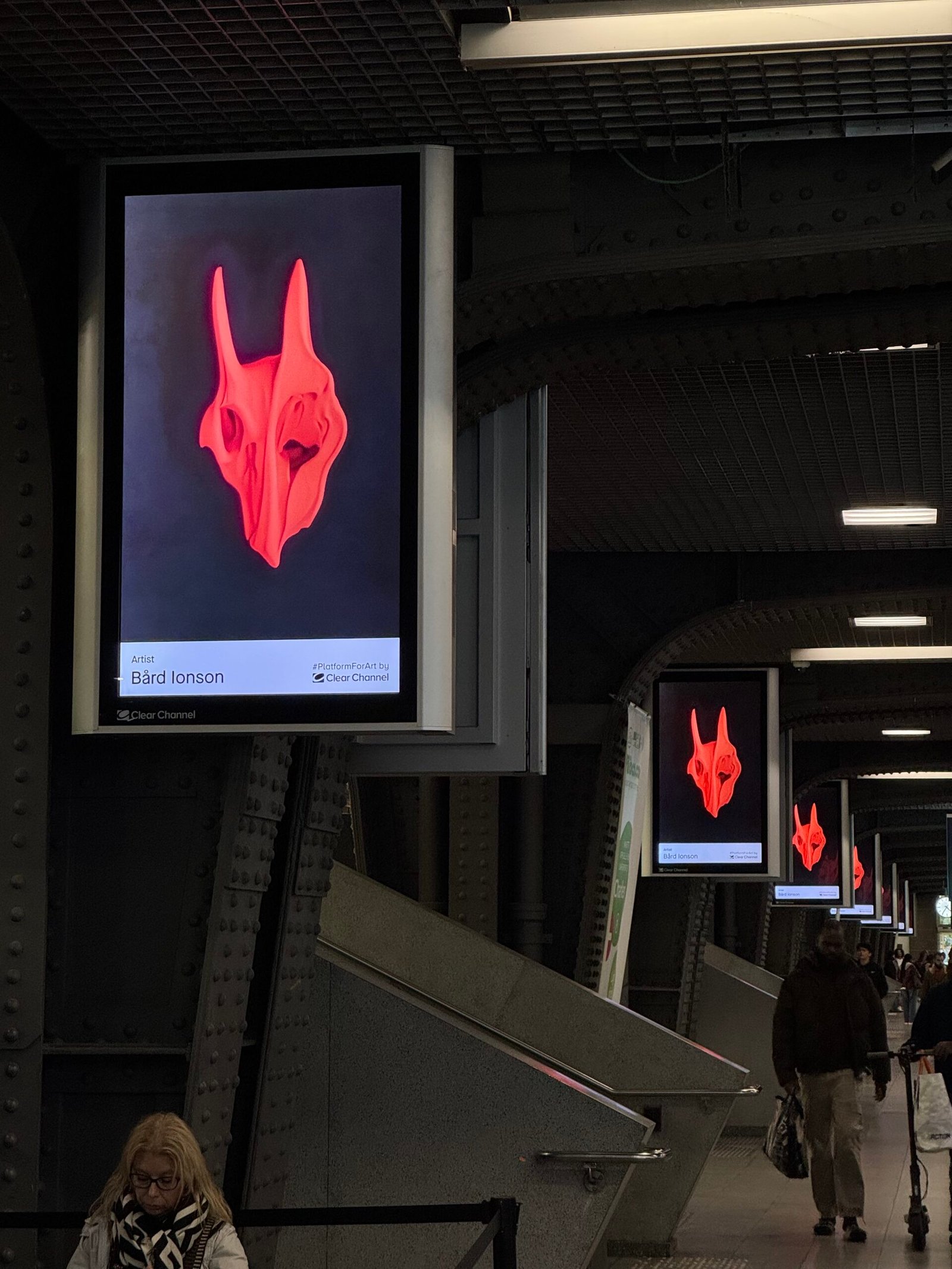 Ai art of a red bone skull on a line of digital signs in a Brussels train station